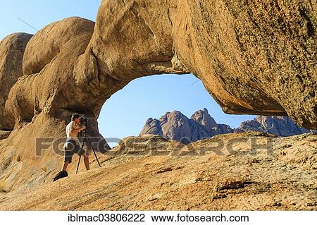 "Photographer at a rock bridge, Damaraland, Namibia, Africa" View Large Photo Image Stock Image - "Photographer at a rock bridge, Damaraland, Namibia, Africa". Fotosearch