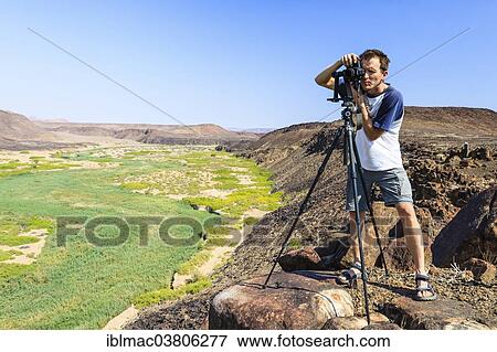 "Photographer with a camera at the Huab River, Damaraland, Namibia, Africa" View Large Photo Image Stock Photo - "Photographer with a camera at the Huab River, Damaraland, Namibia, Africa". Fotosearch