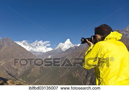 "Photographer with yellow jacket taking a photograph of Mount Everest Mountain from Everest View Hotel viewpoint, Solo Khumbu, Namche Bazar, Solukhumbu District, Sagarmatha Zone, Nepal, Asia" View Large Photo Image Stock Photo - "Photographer with yellow jacket taking a photograph of Mount Everest Mountain from Everest View Hotel viewpoint, Solo Khumbu, Namche Bazar, Solukhumbu District, Sagarmatha Zone, Nepal, Asia". Fotosearch