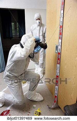 "Photographic securing of forensic evidence, by officer of the C. I. D., the Criminal Investigation Department, gathering forensic evidence at the scene of a crime, after a capital offence, homicide, re-enacted scene" View Large Photo Image Stock Photo - "Photographic securing of forensic evidence, by officer of the C. I. D., the Criminal Investigation Department, gathering forensic evidence at the scene of a crime, after a capital offence, homicide, re-enacted scene". Fotosearch