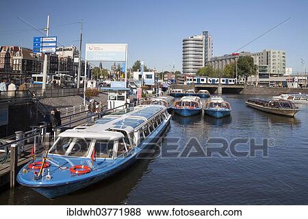 "Pier, boats for canal cruises, Amsterdam, North Holland province, Netherlands" View Large Photo Image Stock Photo - "Pier, boats for canal cruises, Amsterdam, North Holland province, Netherlands". Fotosearch