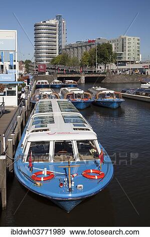 "Pier, boats for canal cruises, Amsterdam, North Holland province, Netherlands" View Large Photo Image Stock Photo - "Pier, boats for canal cruises, Amsterdam, North Holland province, Netherlands". Fotosearch