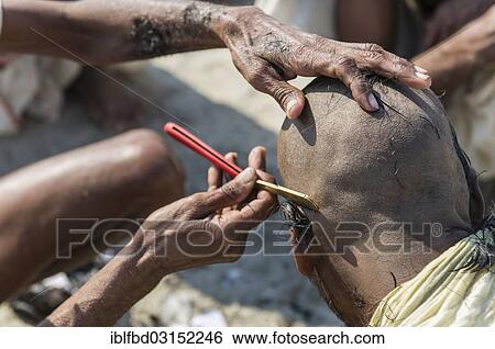 Stock Photograph - "Pilgrim having his head shaved during Kumbha Mela, Allahabad, Uttar Pradesh, India, Asia". Fotosearch