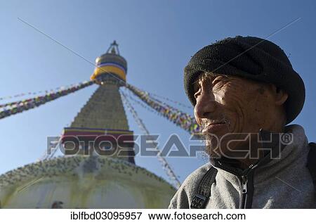Stock Photo - "Pilgrim in front of Boudnath Stupa, Kathmandu Valley, Kathmandu, Kathmandu District, Bagmati Zone, Nepal, Asia". Fotosearch