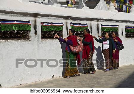 Picture - "Pilgrims walking around Boudnath Stupa, turning prayer wheels, Kathmandu Valley, Kathmandu, Kathmandu District, Bagmati Zone, Nepal, Asia". Fotosearch