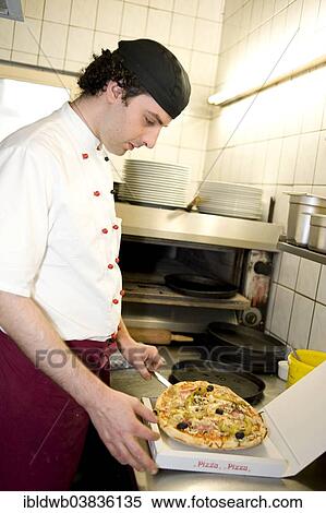 "Pizza baker putting a pizza in a pizza box, Upper Bavaria, Bavaria, Munich, Germany, Europe" View Large Photo Image Stock Photography - "Pizza baker putting a pizza in a pizza box, Upper Bavaria, Bavaria, Munich, Germany, Europe". Fotosearch