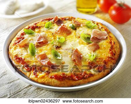 Stock Photo - "Pizza topped with 3 cheeses, Parma ham and basil". Fotosearch