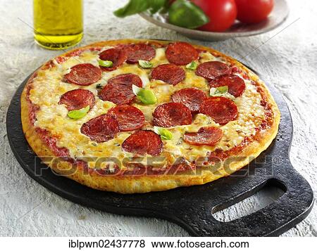 "Pizza topped with pepperoni, cheese, chilli and basil" View Large Photo Image Stock Photo - "Pizza topped with pepperoni, cheese, chilli and basil". Fotosearch