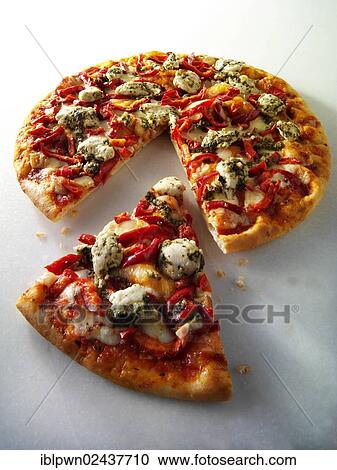 Stock Image - "Pizza topped with pesto, chicken and red peppers". Fotosearch