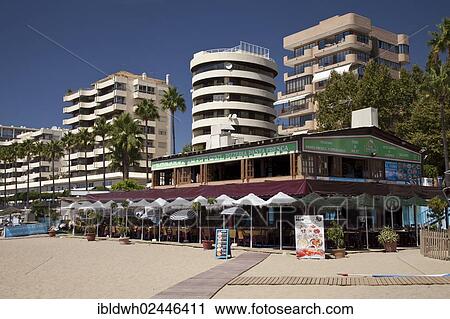 Stock Image - "Pizzeria, hotels and apartment houses, sandy beach, Marbella, Costa del Sol, Andalusia, Spain, Europe, PublicGround, Europe". Fotosearch