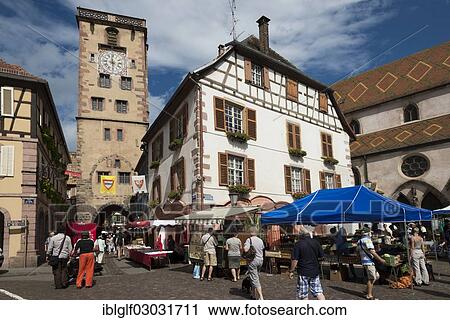 Stock Image - "Place de Hotel de Ville with a market and the city tower, historic center, Ribeauville, Alsace, France, Europe". Fotosearch