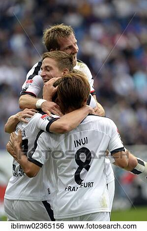Stock Photograph - "Players of Eintracht Frankfurt celebrating a goal by Pirmin Schwegler, Wirsol Rhein-Neckar-Arena, Sinsheim-Hoffenheim, Baden-Wuerttemberg, Germany, Europe". Fotosearch