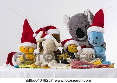 Stock Photo - Plush toys wearing Santa Claus hats. Fotosearch