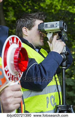 "Police during speed monitoring with a laser gun or hand-held laser meter, North Rhine-Westphalia, Germany, Europe" View Large Photo Image Stock Image - "Police during speed monitoring with a laser gun or hand-held laser meter, North Rhine-Westphalia, Germany, Europe". Fotosearch