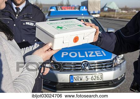 "Policeman checking a first aid box during a traffic control, Germany, Europe" View Large Photo Image Stock Photograph - "Policeman checking a first aid box during a traffic control, Germany, Europe". Fotosearch