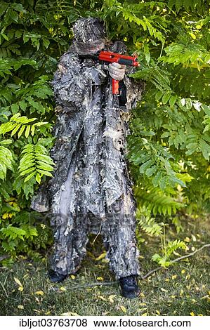 "Policeman dressed in camouflage with a submachine gun HK MP5, not capable of shooting, marked red, during an exercise of the NRW Police special task forces, North Rhine-Westphalia, Germany, Europe" View Large Photo Image Stock Photo - "Policeman dressed in camouflage with a submachine gun HK MP5, not capable of shooting, marked red, during an exercise of the NRW Police special task forces, North Rhine-Westphalia, Germany, Europe". Fotosearch