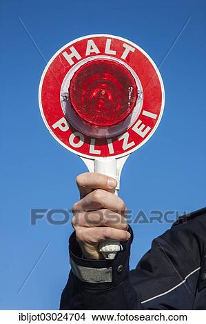 "Policeman holding a police signalling disc, Germany, Europe" View Large Photo Image Picture - "Policeman holding a police signalling disc, Germany, Europe". Fotosearch