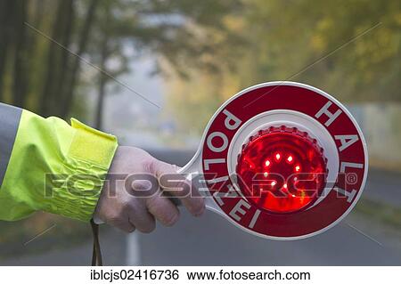 Policeman holding a signalling disc, lettering Halt, Polizei, German for Stop, Police, speed control, on 24/10/2012, Oberbergischer Kreis district, Lindlar, North Rhine-Westphalia, Germany, Europe View Large Photo Image Stock Photograph - Policeman holding a signalling disc, lettering Halt, Polizei, German for Stop, Police, speed control, on 24/10/2012, Oberbergischer Kreis district, Lindlar, North Rhine-Westphalia, Germany, Europe. Fotosearch
