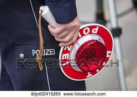 Policeman holding a signalling disc, extensive speed controls in North Rhine-Westphalia on 24. 10. 2012, Recklinghausen, North Rhine-Westphalia, Germany, Europe View Large Photo Image Stock Photography - Policeman holding a signalling disc, extensive speed controls in North Rhine-Westphalia on 24. 10. 2012, Recklinghausen, North Rhine-Westphalia, Germany, Europe. Fotosearch