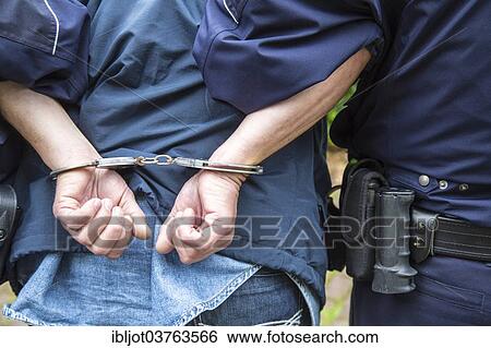 "Policeman leading a man in handcuffs, North Rhine-Westphalia, Germany, Europe" View Large Photo Image Stock Photograph - "Policeman leading a man in handcuffs, North Rhine-Westphalia, Germany, Europe". Fotosearch