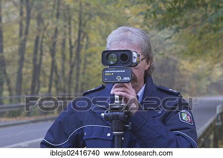 Policeman operating a radar gun, speed control, on 24/10/2012, Oberbergischer Kreis district, Lindlar, North Rhine-Westphalia, Germany, Europe View Large Photo Image Stock Image - Policeman operating a radar gun, speed control, on 24/10/2012, Oberbergischer Kreis district, Lindlar, North Rhine-Westphalia, Germany, Europe. Fotosearch