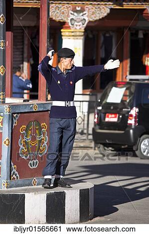 Stock Image - "Policeman regulating traffic at traffic light free main crossing, Thimphu, Bhutan, Asia". Fotosearch