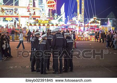 Stock Photography - "Policemen, Cannstatter Wasen fairground, funfair, Bad Cannstatt, Stuttgart, Baden-Wuerttemberg, Germany, Europe". Fotosearch
