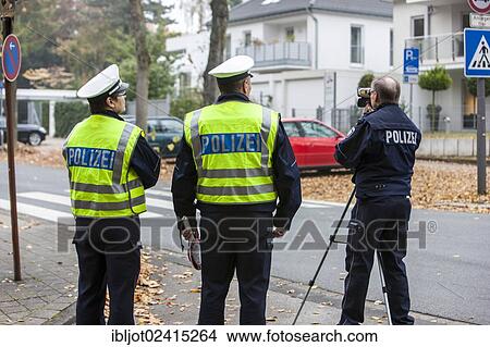 Policemen operating a laser speed gun, extensive speed controls in North Rhine-Westphalia on 24. 10. 2012, Recklinghausen, North Rhine-Westphalia, Germany, Europe View Large Photo Image Picture - Policemen operating a laser speed gun, extensive speed controls in North Rhine-Westphalia on 24. 10. 2012, Recklinghausen, North Rhine-Westphalia, Germany, Europe. Fotosearch