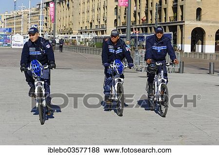Stock Photo - "Policemen riding bicycles in the town centre, Marseille, Departement Bouches-du-Rhone, Region Provence-Alpes-Cote dâ€™Azur dâ€™Azur, France, Europe". Fotosearch