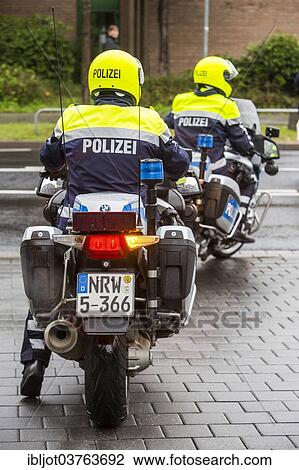 "Policemen wearing yellow helmets on motorcycles, police motorcycle patrol of the NRW Police, Germany, Europe" View Large Photo Image Stock Image - "Policemen wearing yellow helmets on motorcycles, police motorcycle patrol of the NRW Police, Germany, Europe". Fotosearch