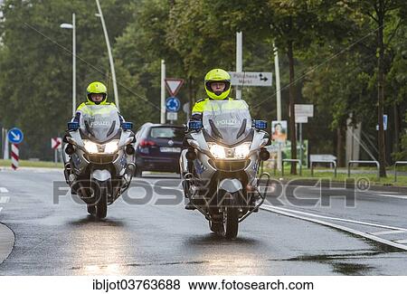 Stock Photo - "Policemen wearing yellow helmets on motorcycles, police motorcycle patrol of the NRW Police, Germany, Europe". Fotosearch