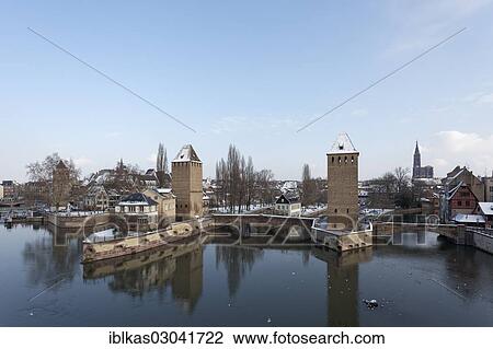 Stock Image - "Ponts couverts or covered bridges over the Ill River and towers of the city wall in winter, Petite-France, Strasbourg, Departement Bas-Rhin, Alsace, France, Europe". Fotosearch