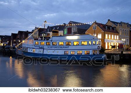 "Port of Husum with a boat restaurant during the blue hour, North Frisia, Husum, Schleswig-Holstein, Germany, Europe" View Large Photo Image Stock Photo - "Port of Husum with a boat restaurant during the blue hour, North Frisia, Husum, Schleswig-Holstein, Germany, Europe". Fotosearch