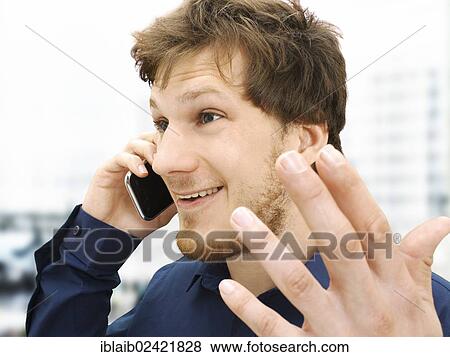 Portrait of a businessman making a telephone call, gesticulating, friendly, optimistic View Large Photo Image Stock Photo - Portrait of a businessman making a telephone call, gesticulating, friendly, optimistic. Fotosearch