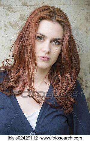 Stock Image - Portrait of a confident young woman with red hair. Fotosearch