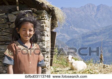 "Portrait of a local girl with house and goat in the back, Bhandar, Solukhumbu District, Sagarmatha Zone, Nepal, Asia" View Large Photo Image Stock Photo - "Portrait of a local girl with house and goat in the back, Bhandar, Solukhumbu District, Sagarmatha Zone, Nepal, Asia". Fotosearch