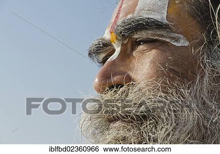 Stock Photograph - "Portrait of a male pilgrim, praying at Sangam, the confluence of the holy rivers Ganges, Yamuna and Saraswati, Allahabad, India, Asia". Fotosearch