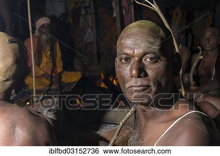 Stock Photograph - "Portrait of a man joining the initiation of new sadhus, during Kumbha Mela festival at night, Allahabad, Uttar Pradesh, India, Asia". Fotosearch