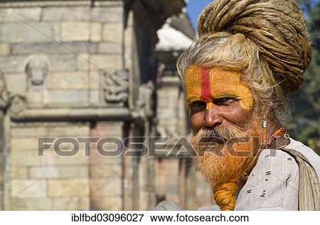 Stock Photo - "Portrait of a Sadhu, Holy Man, sitting opposite the burning ghats, Kathmandu, Kathmandu District, Bagmati Zone, Nepal, Asia". Fotosearch