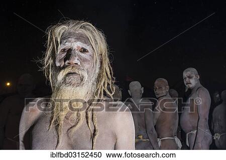 Stock Image - "Portrait of a Shiva sadhu from Avahan Akhara, within a group of fellow sadhus, during Kumbha Mela festival, Allahabad, Uttar Pradesh, India, Asia". Fotosearch