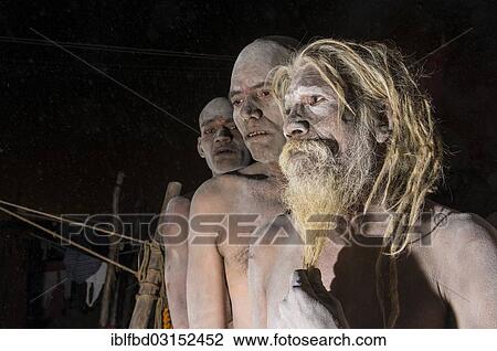 Stock Image - "Portrait of a Shiva sadhu from Avahan Akhara, within a group of fellow sadhus, during Kumbha Mela festival, Allahabad, Uttar Pradesh, India, Asia". Fotosearch