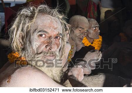 Stock Image - "Portrait of a Shiva sadhu from Avahan Akhara, within a group of fellow sadhus, during Kumbha Mela festival, Allahabad, Uttar Pradesh, India, Asia". Fotosearch