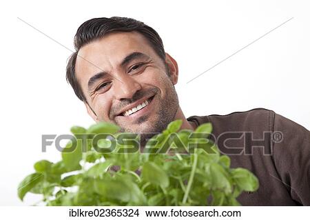 Portrait of a smiling man with basil View Large Photo Image Picture - Portrait of a smiling man with basil. Fotosearch