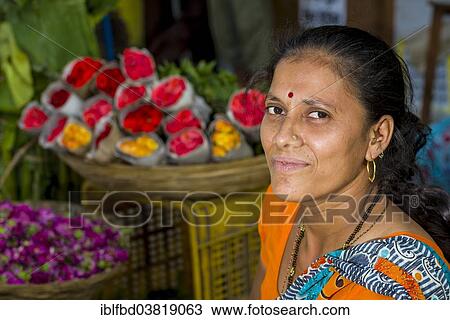 "Portrait of a woman selling flowers at an open air market, Mumbai, Maharashtra, India, Asia" View Large Photo Image Stock Image - "Portrait of a woman selling flowers at an open air market, Mumbai, Maharashtra, India, Asia". Fotosearch