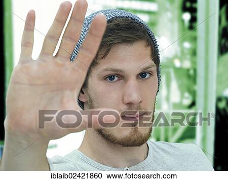 Portrait of a young man with a bear with a woolly hat, defensive gesture, irritated View Large Photo Image Stock Image - Portrait of a young man with a bear with a woolly hat, defensive gesture, irritated. Fotosearch