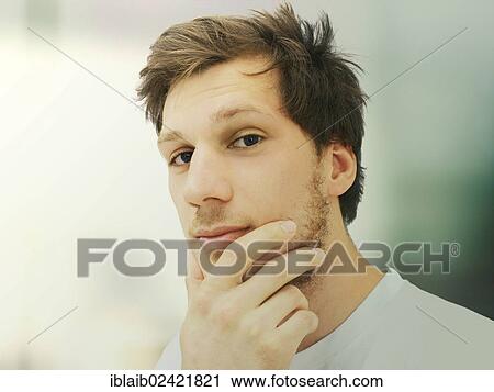 Portrait of a young man with a beard, student, serious, relaxed, calm View Large Photo Image Stock Image - Portrait of a young man with a beard, student, serious, relaxed, calm. Fotosearch