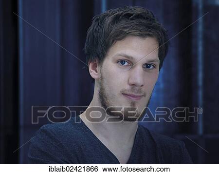 Portrait of a young man with a beard, looking serious, calm, relaxed View Large Photo Image Stock Photograph - Portrait of a young man with a beard, looking serious, calm, relaxed. Fotosearch