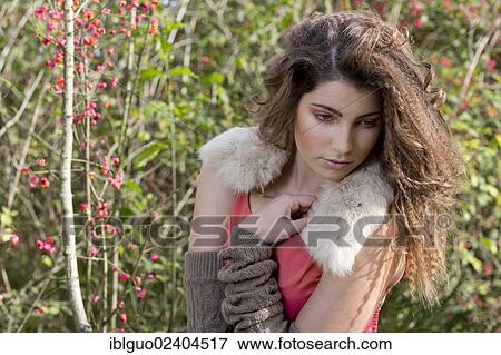 Stock Photo - Portrait of a young woman outdoors in autumn. Fotosearch