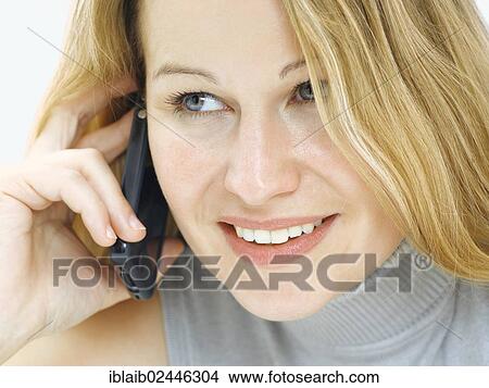 "Portrait of a young woman speaking on her mobile phone, smiling, happy" View Large Photo Image Picture - "Portrait of a young woman speaking on her mobile phone, smiling, happy". Fotosearch