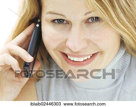 "Portrait of a young woman speaking on her mobile phone, smiling, happy" View Large Photo Image Stock Image - "Portrait of a young woman speaking on her mobile phone, smiling, happy". Fotosearch